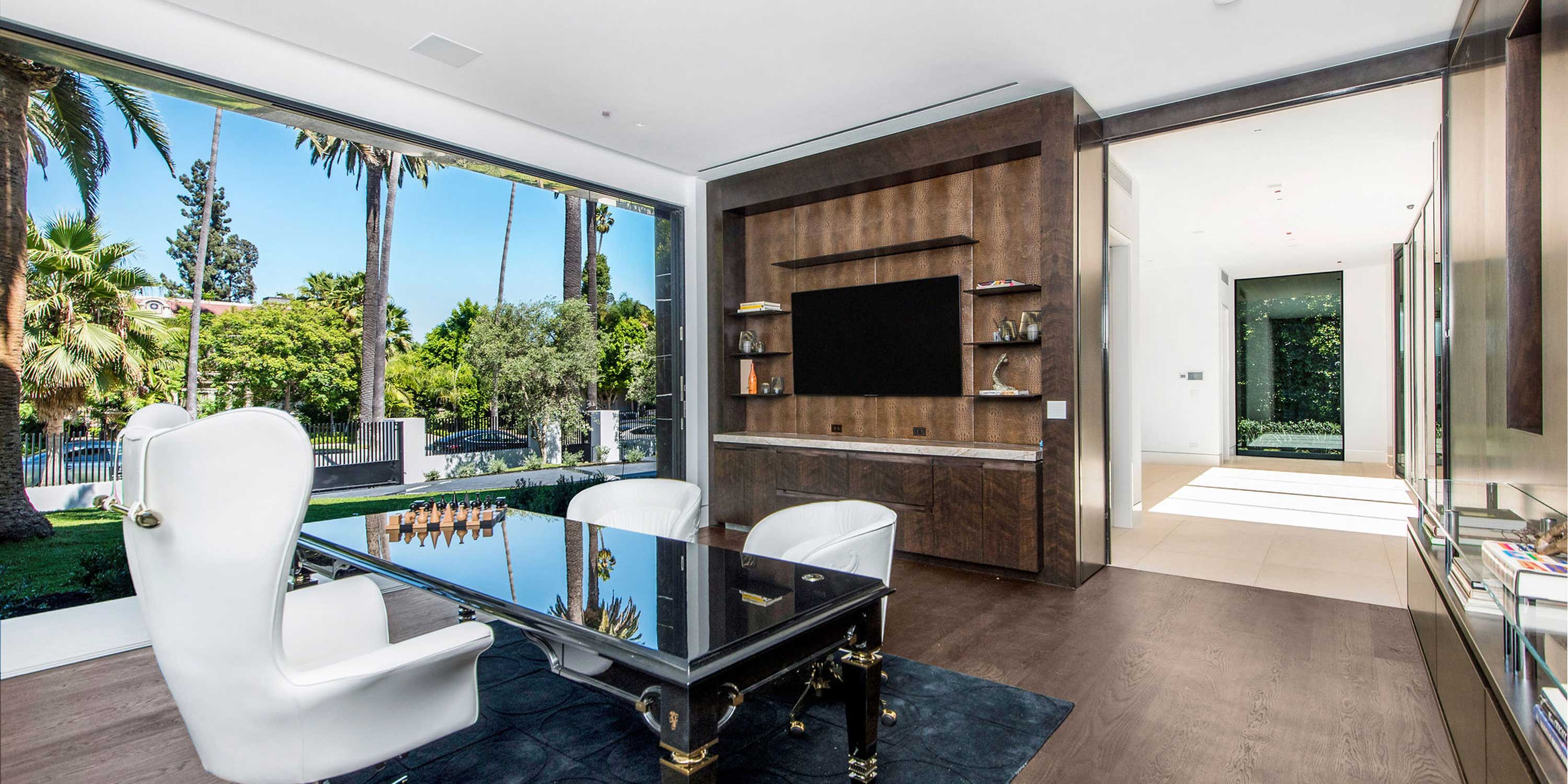 Home Office with large windows and white chairs
