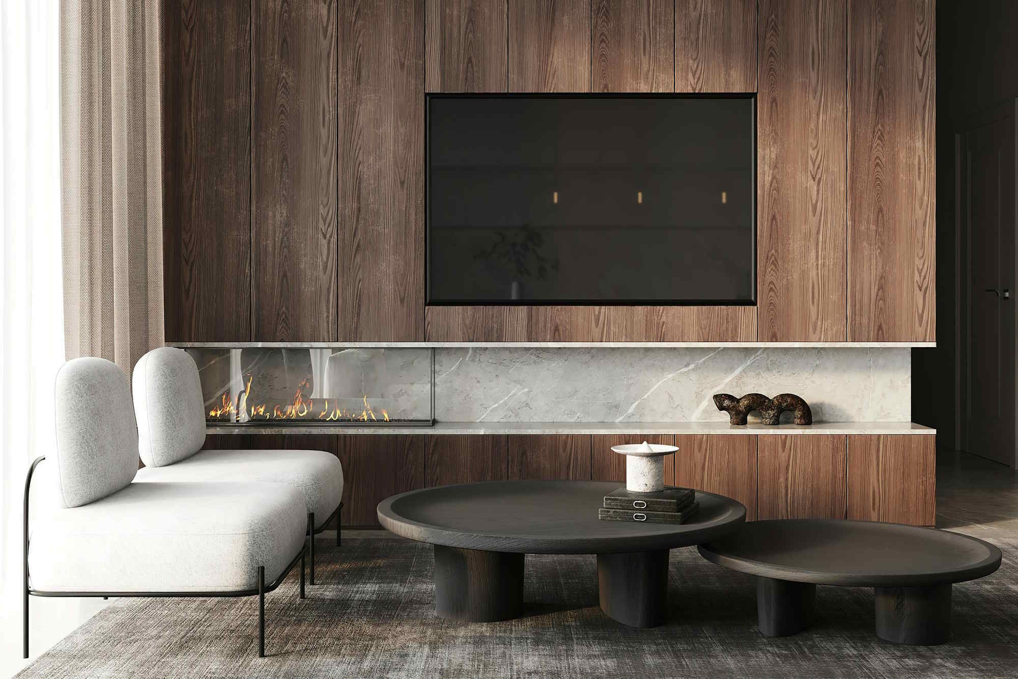 Modern living room with a wood‑paneled TV wall, a long glass‑front fireplace, round coffee tables, and a minimalist gray chair.