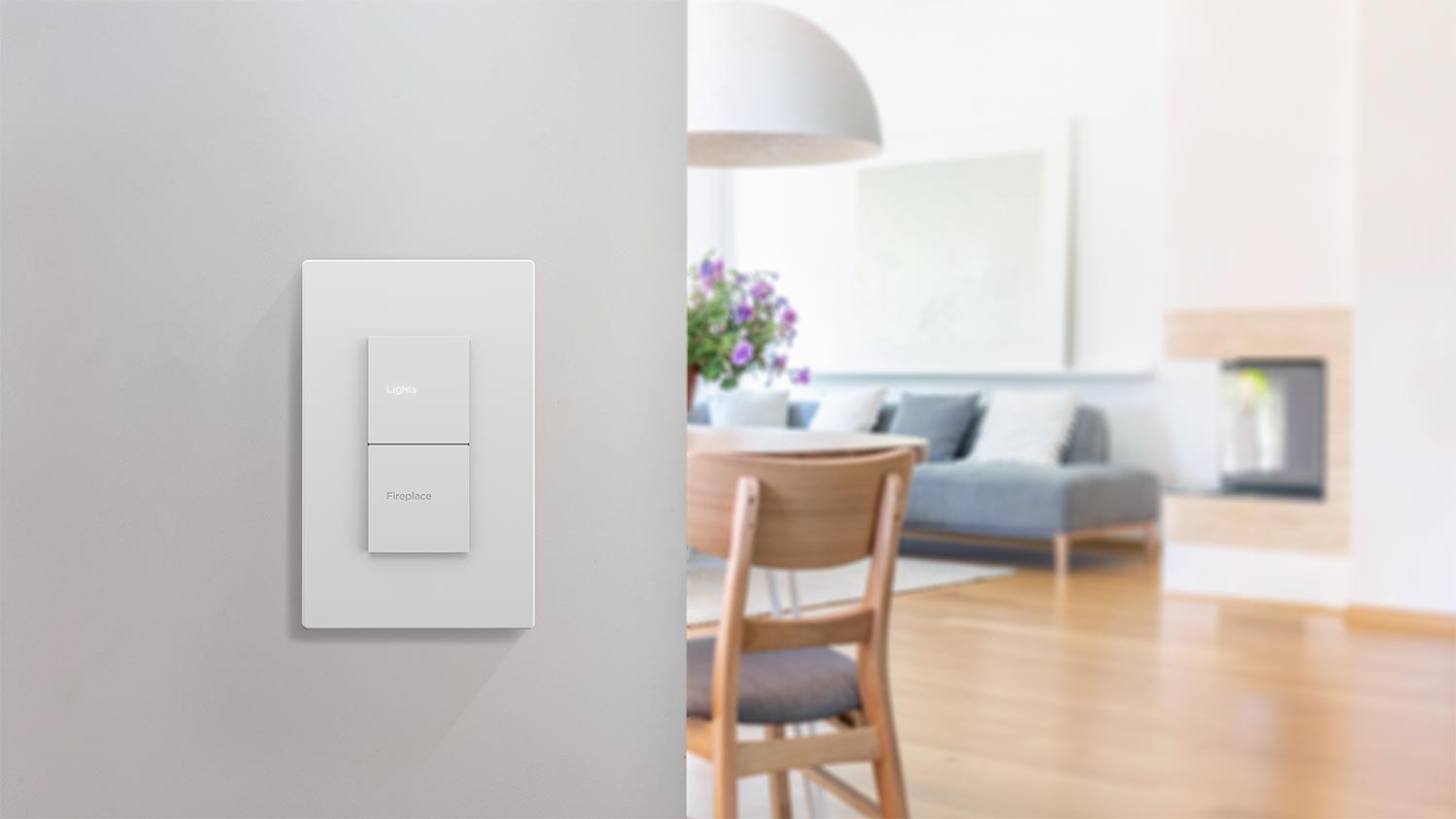Modern white wall switch with buttons for lights and fireplace in a bright living room