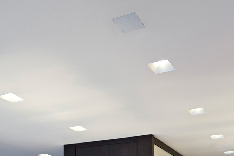 Ceiling with flush-mounted Sonance architectural speakers and recessed lighting, offering a sleek and modern look.