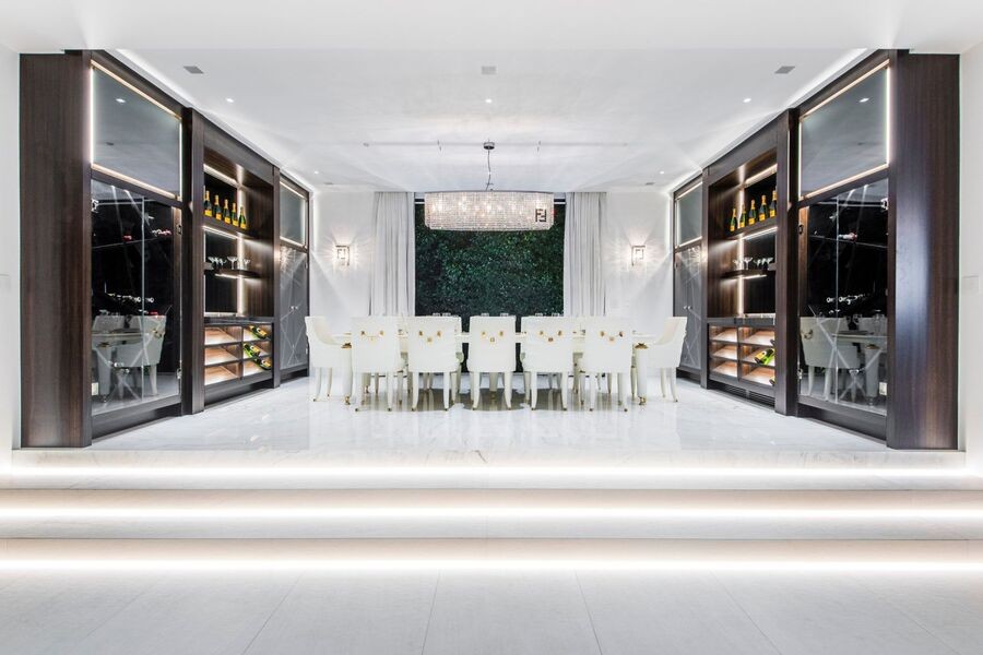 A luxurious dining room with elegant accent and ambient lighting fixtures.