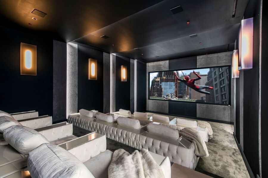 A luxury home theater displaying the Spiderman movie.