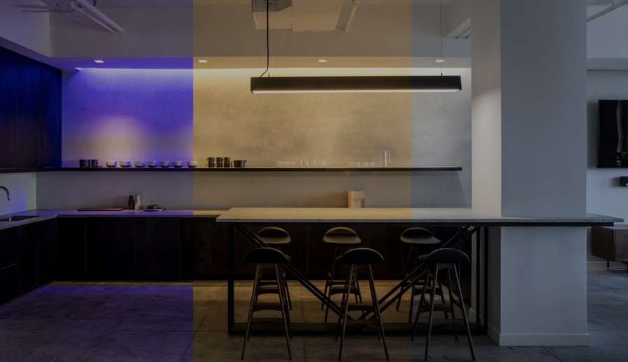 A luxury kitchen illuminated by different shades of Ketra lighting solutions.