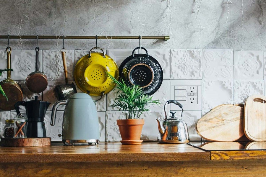 Brightly lit modern kitchen with rustic decor, stylish appliances, and Lutron control keypad. 