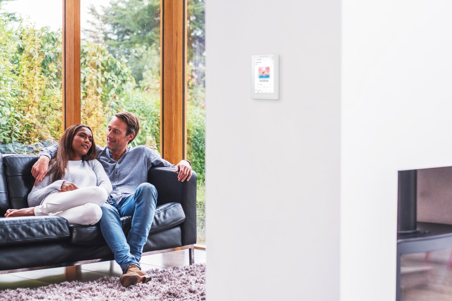 A Crestron control system installed on the living room wall of a luxury home