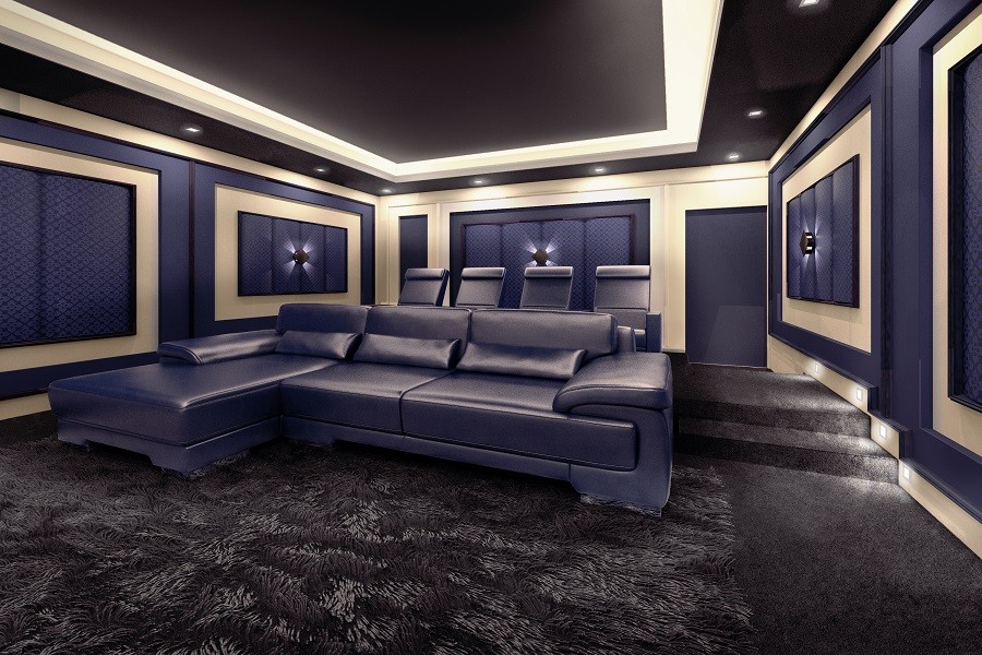 Custom home theater with acoustic panels and decor accents in gold and dark blue with luxury seating at the center.