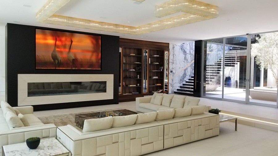 Stunning and sophisticated media room illuminated by natural light and elegant fixtures.