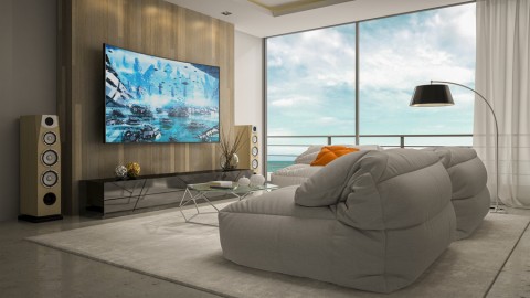 a living room with plush couches, a flat-screen TV, and floor-standing speakers