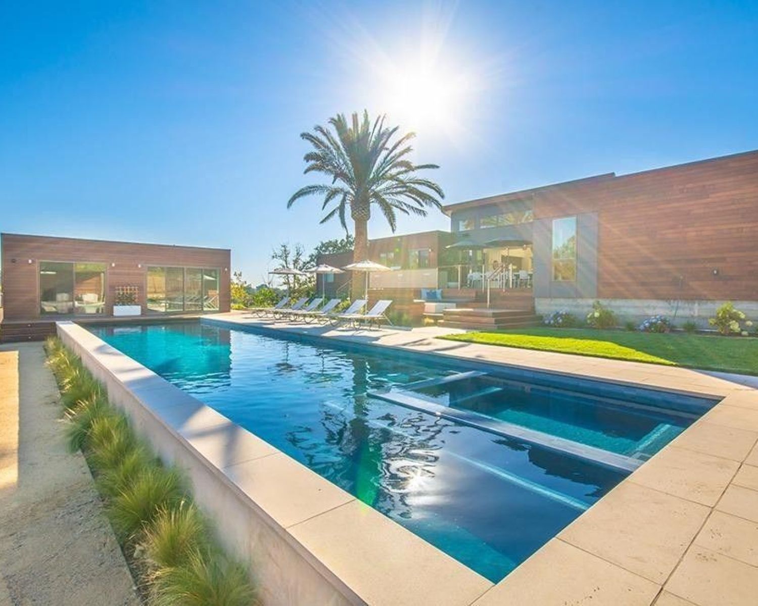 swimming pool with sun shining in the background