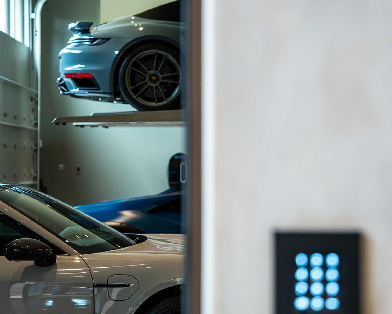Luxury garage with sports cars on stacked parking lifts