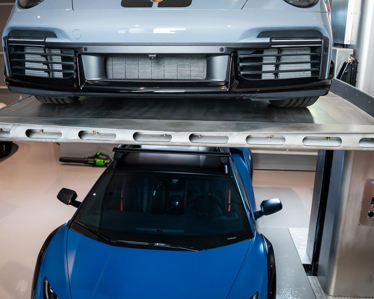 Front view of sports car parked on an elevated garage lift