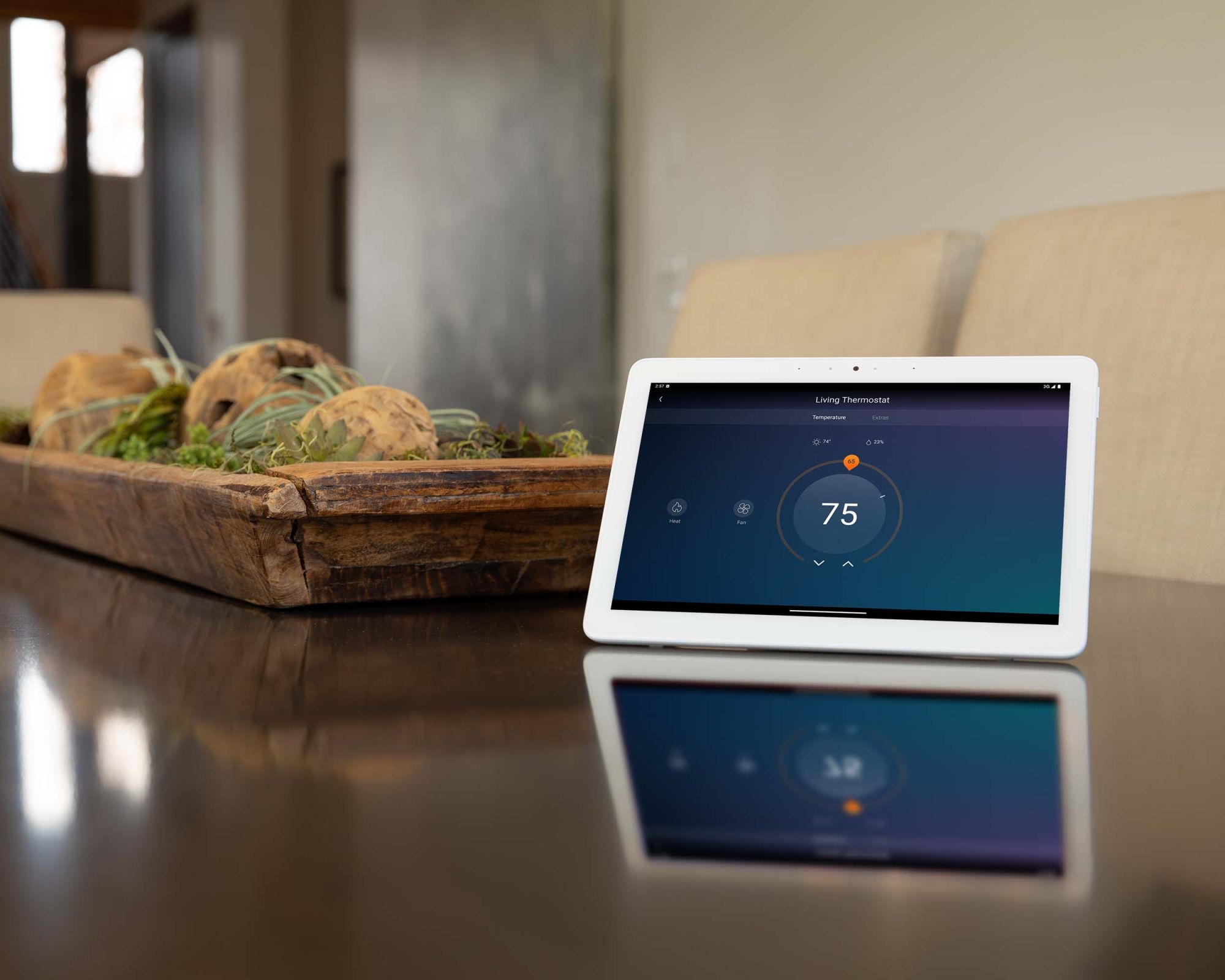 man touching touch panel on wall with control4 thermostat