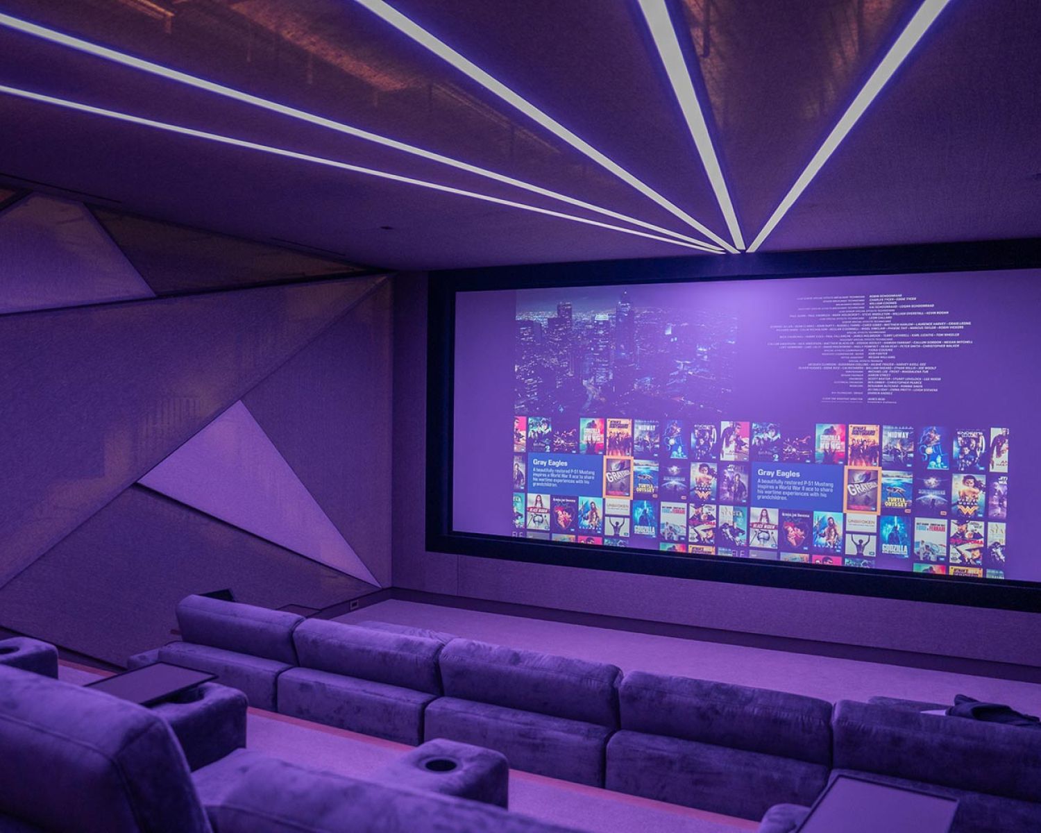 Private home theater with large projection screen and modern seating