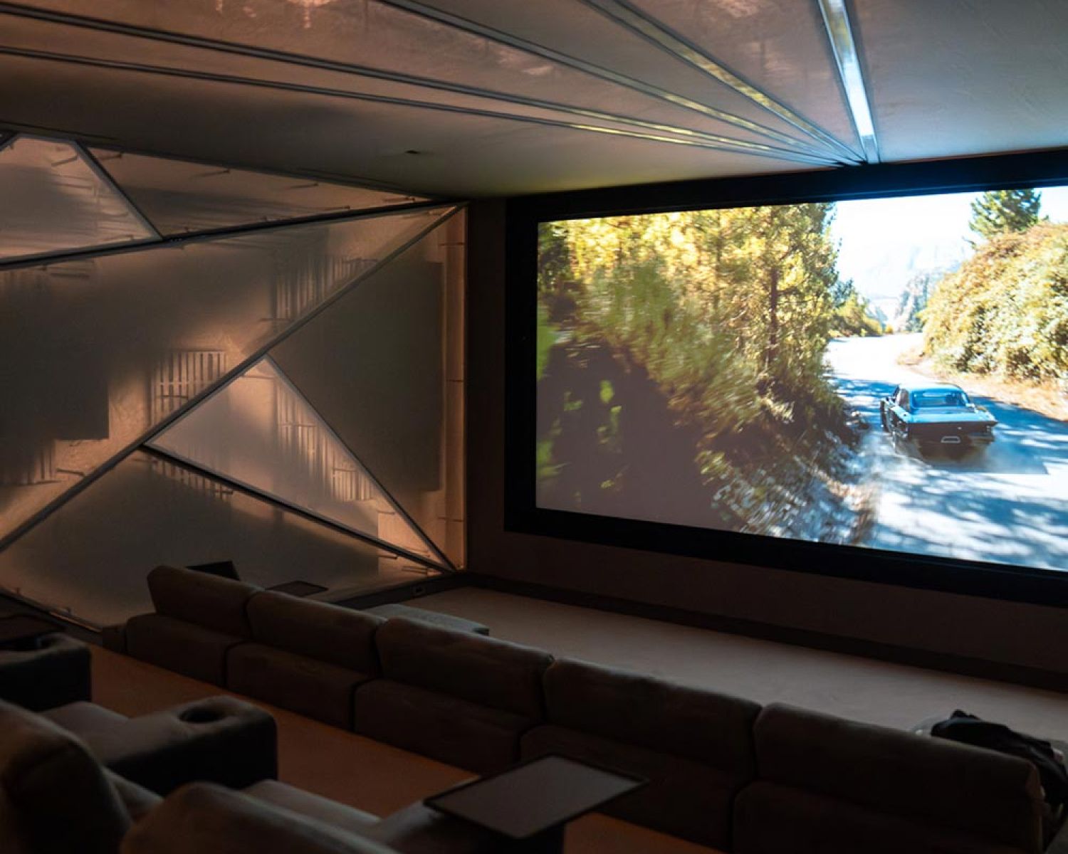 Home theater with large projection screen and tiered seating