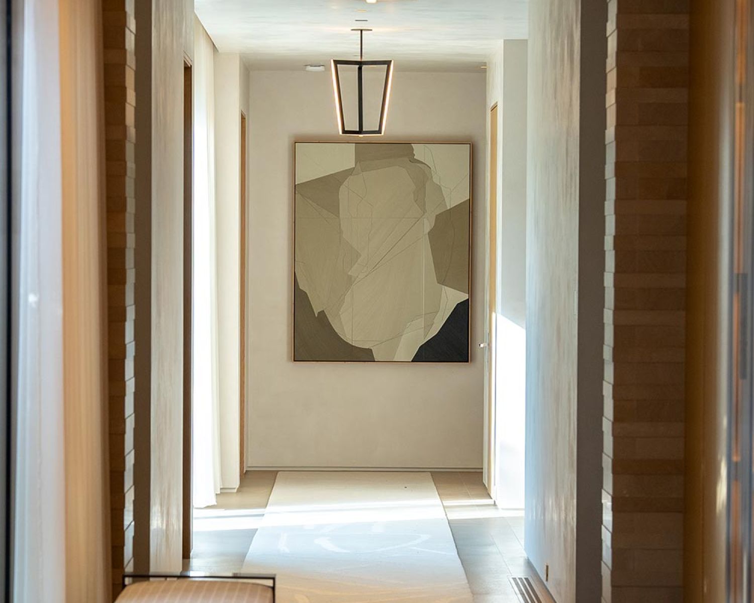 Symmetrical hallway with modern lighting and abstract wall art