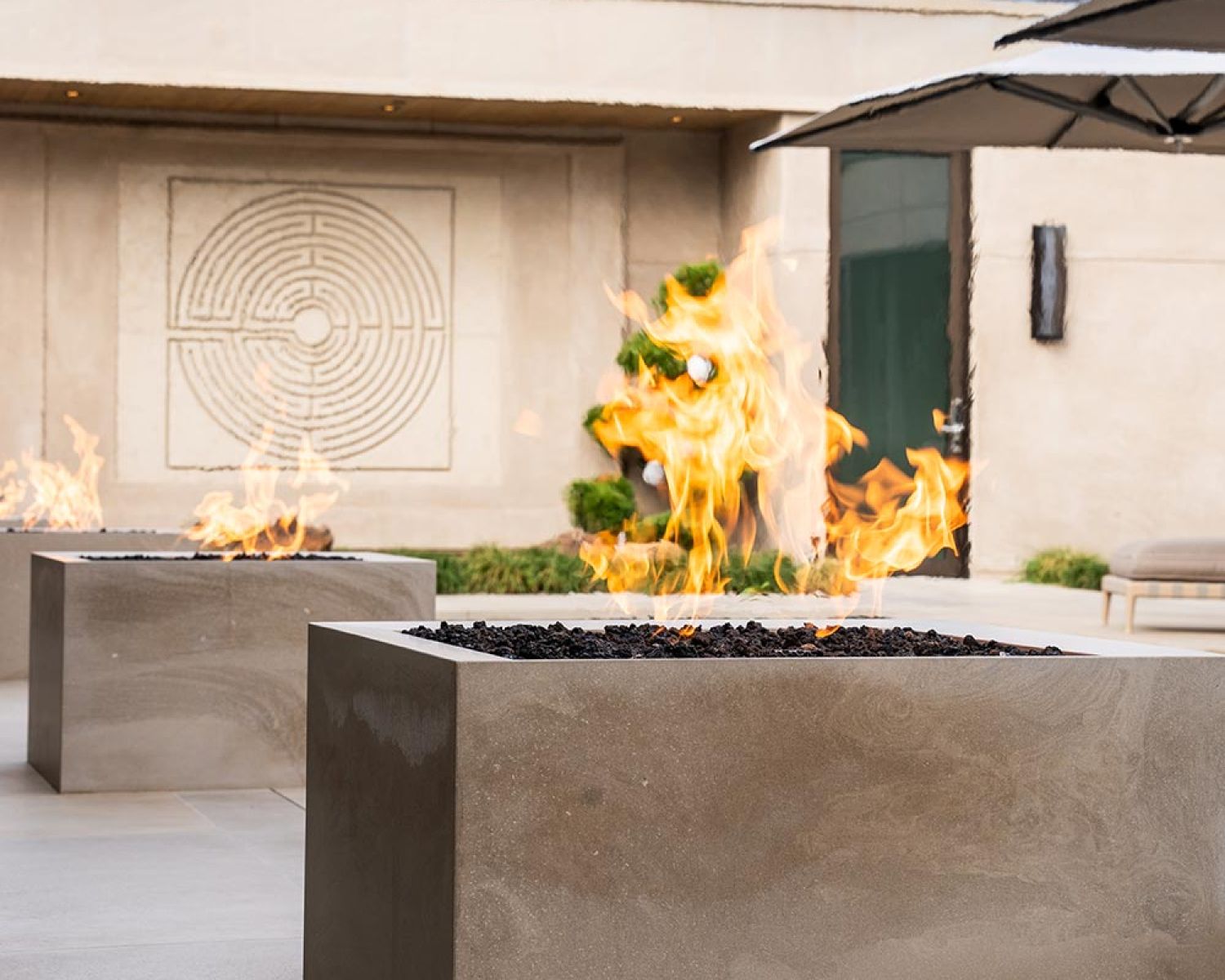 Rectangular outdoor fire feature beside a modern home