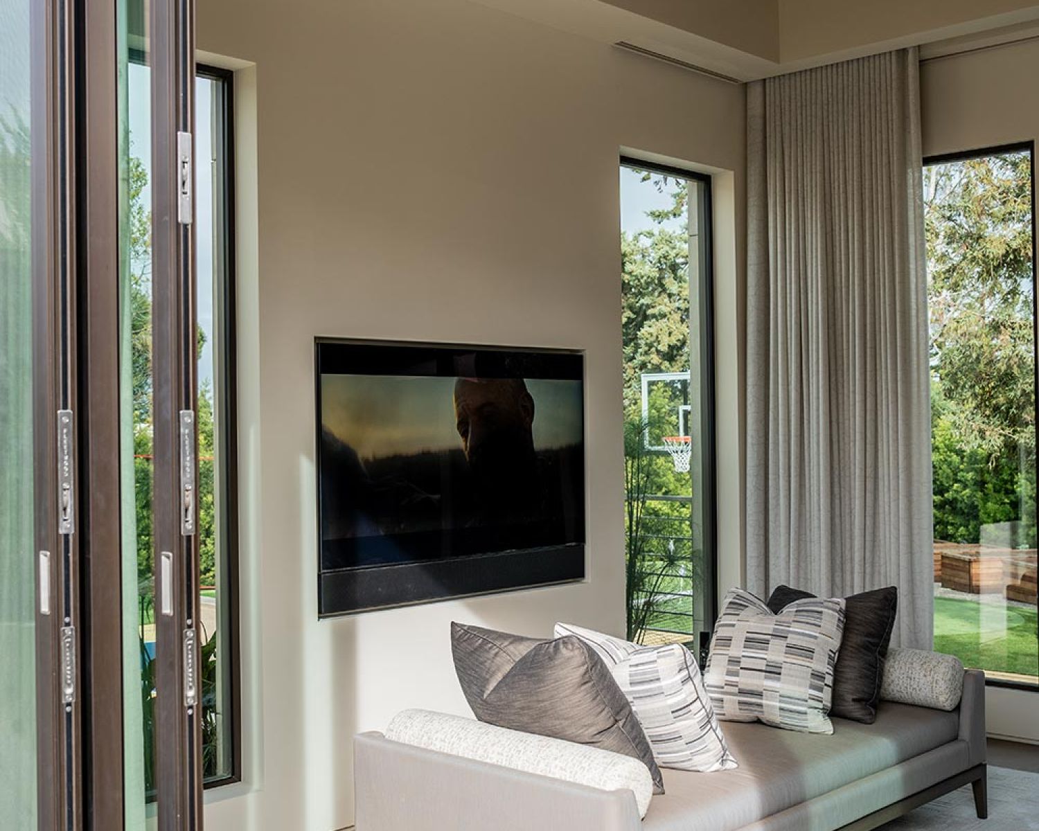Modern living room with wall mounted TV and outdoor view