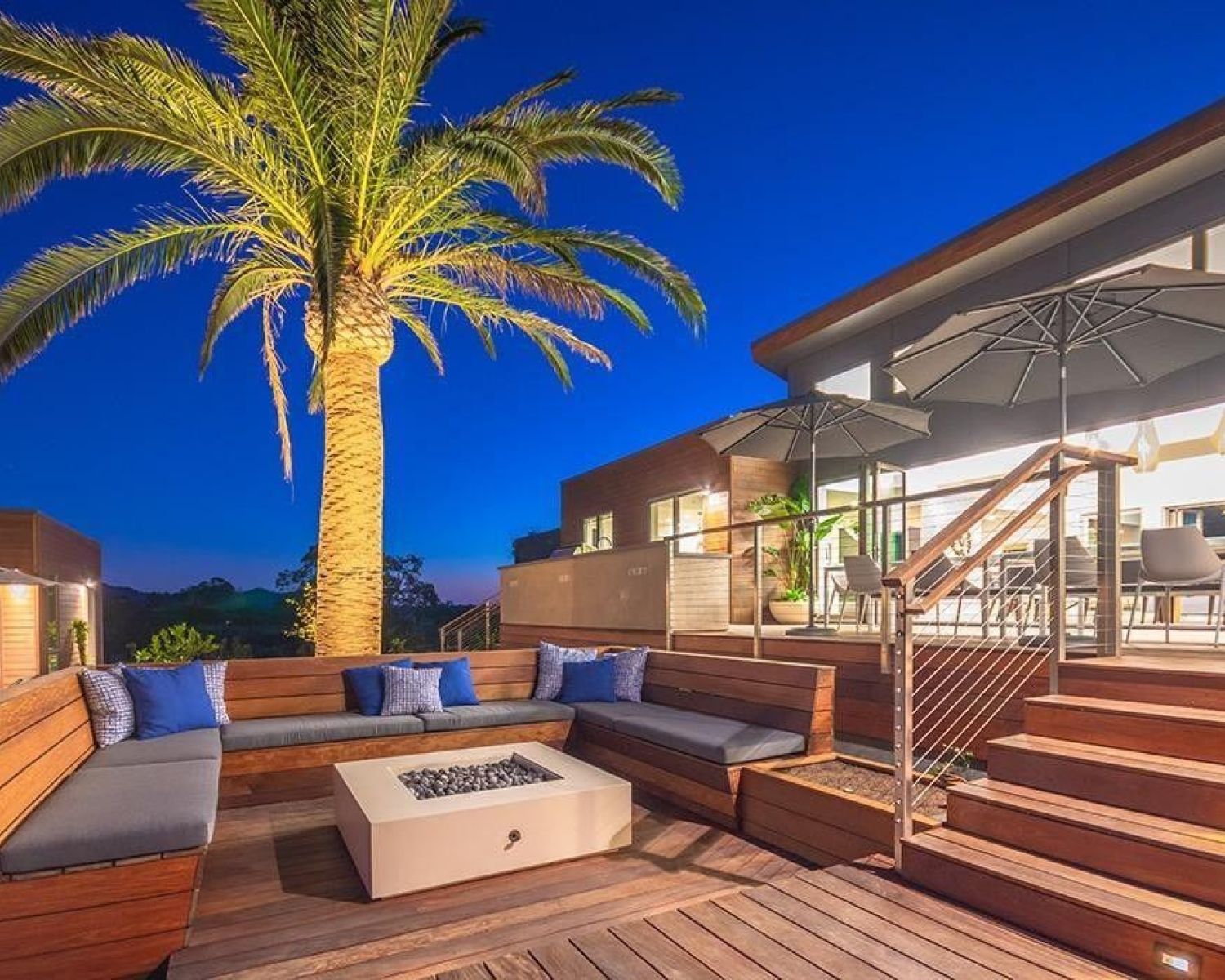 home during the evening with a lit up palm tree