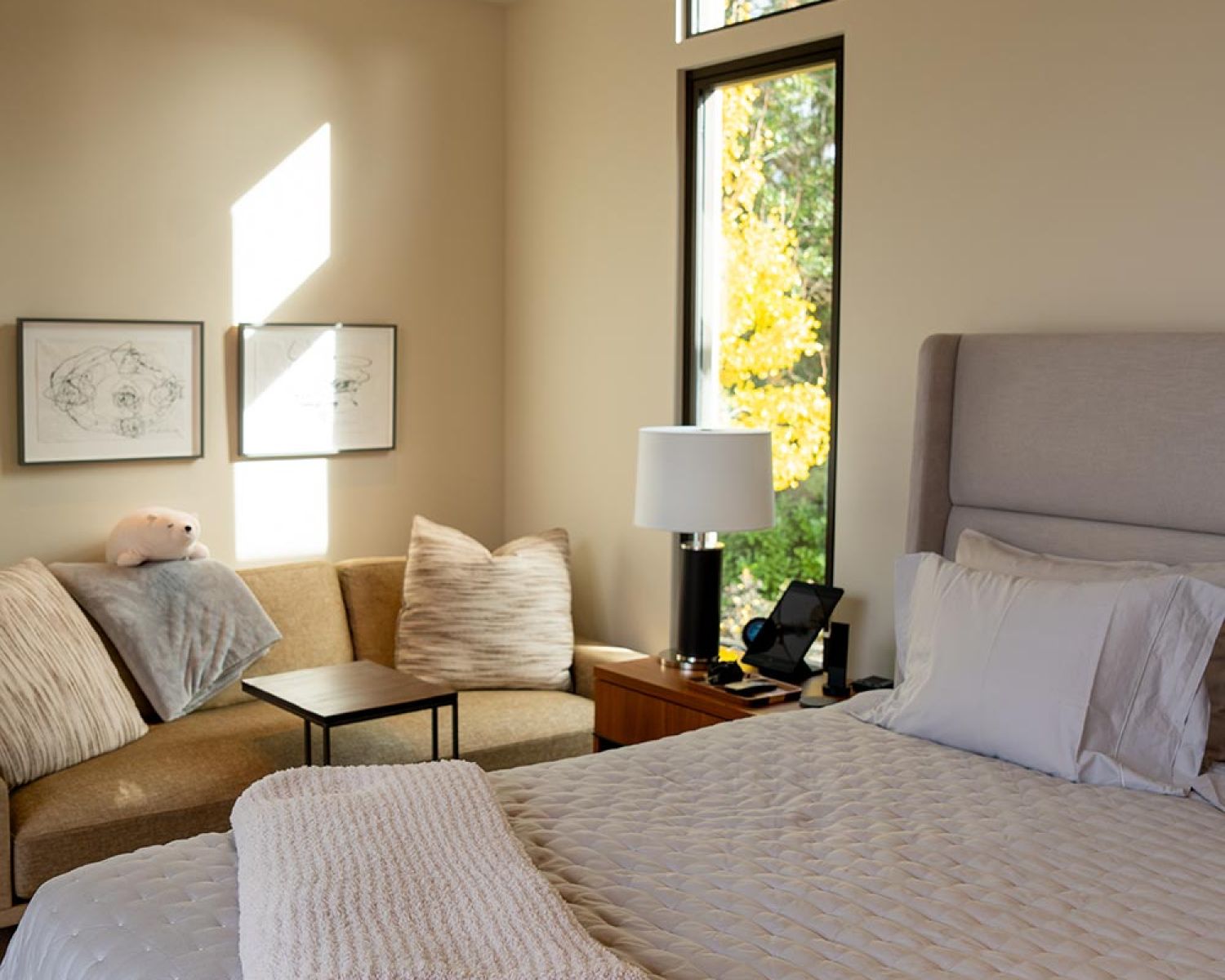 Modern bedroom with upholstered bed and seating area