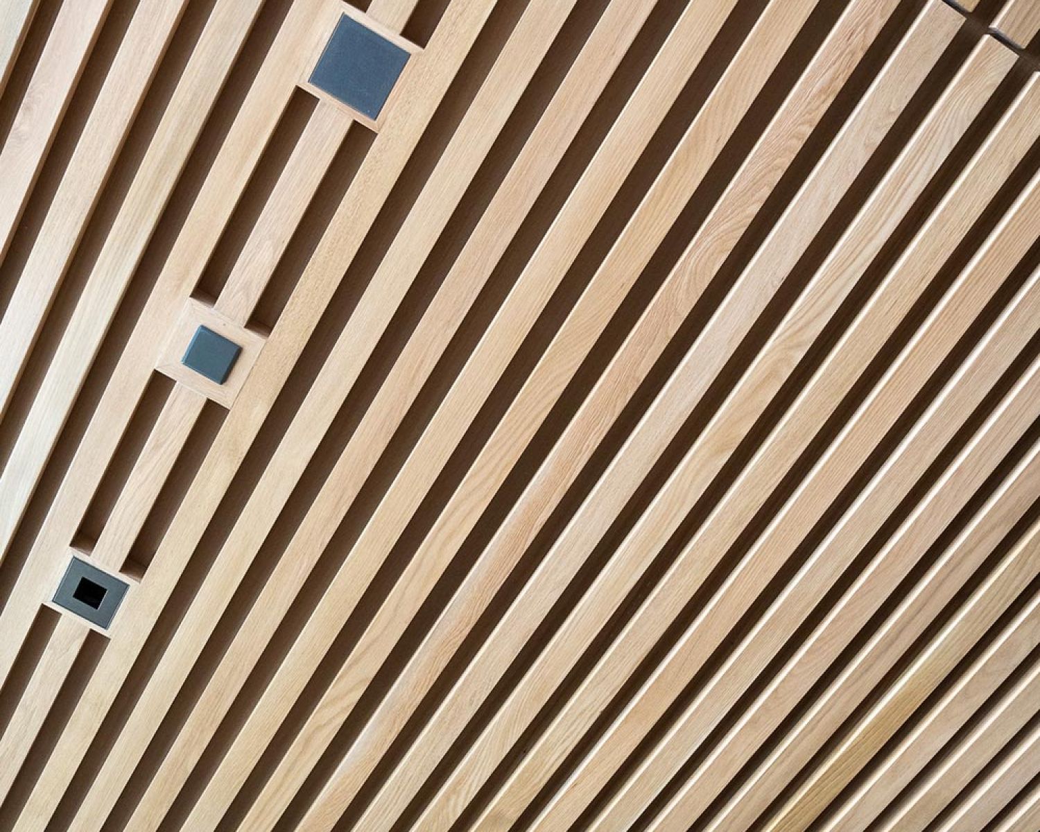 Close view of wood slat ceiling with recessed fixtures