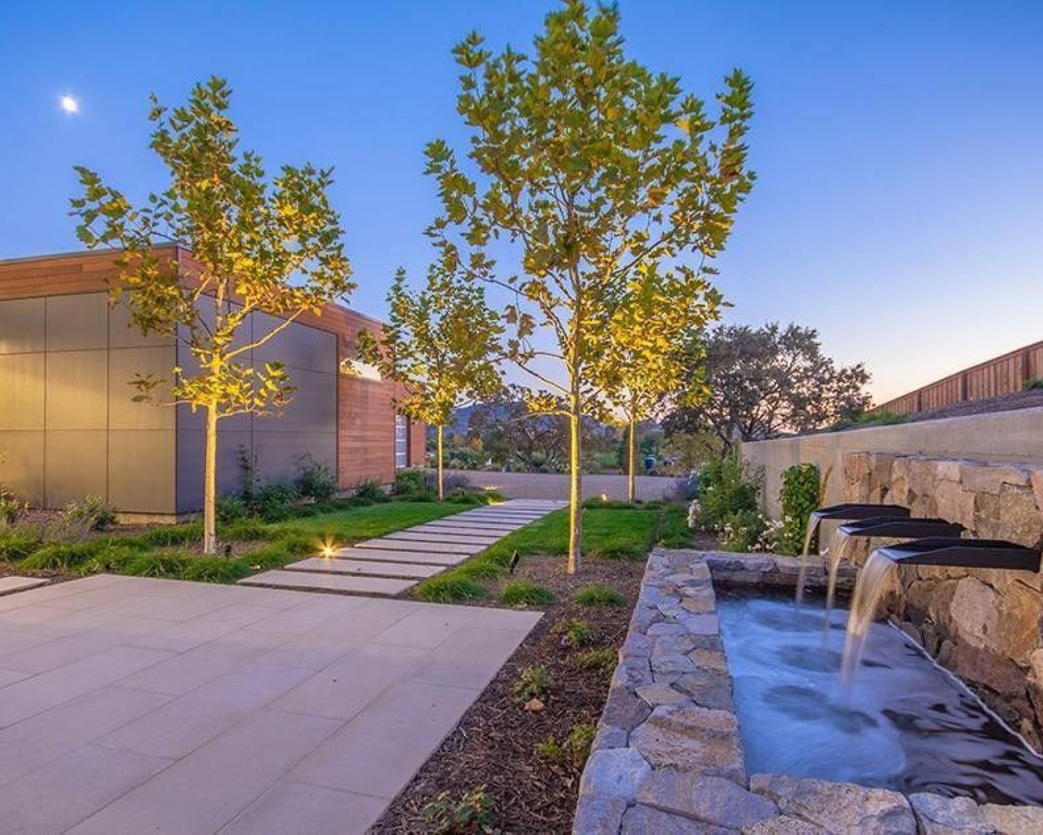 landscape view of modern home with water fixtures