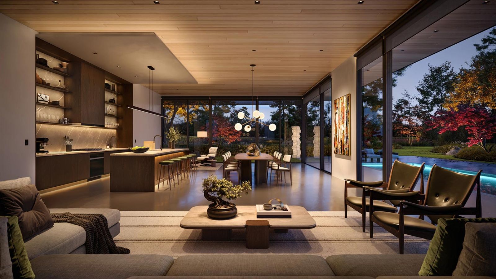 Open living and kitchen area with warm lighting and pool view