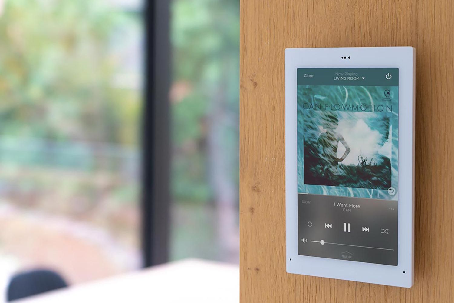 Wall-mounted touchscreen displaying Savant interface for music control