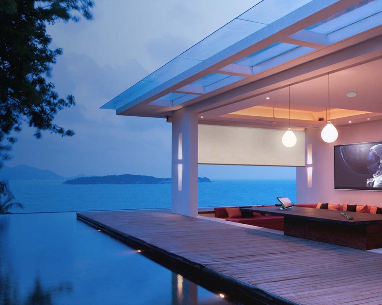 Modern luxury home at dusk with infinity pool