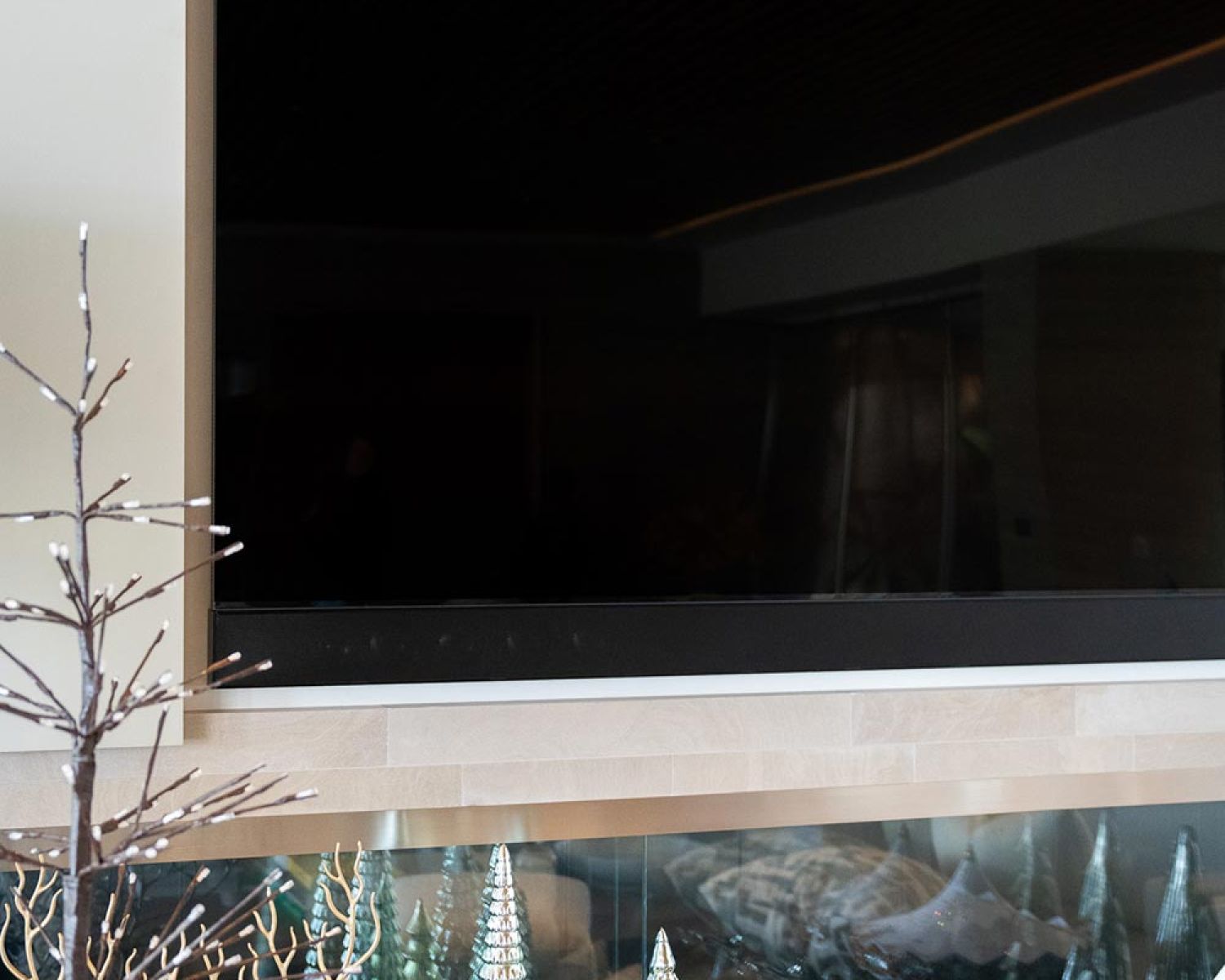 Close view of wall mounted TV with decorative display below