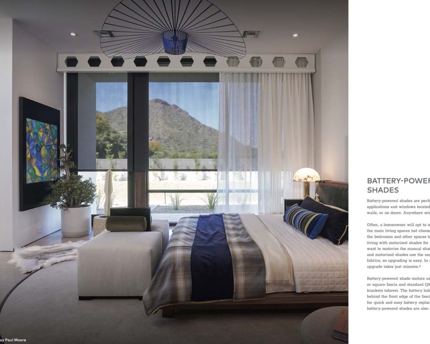 bedroom with blue accents and crestron shades