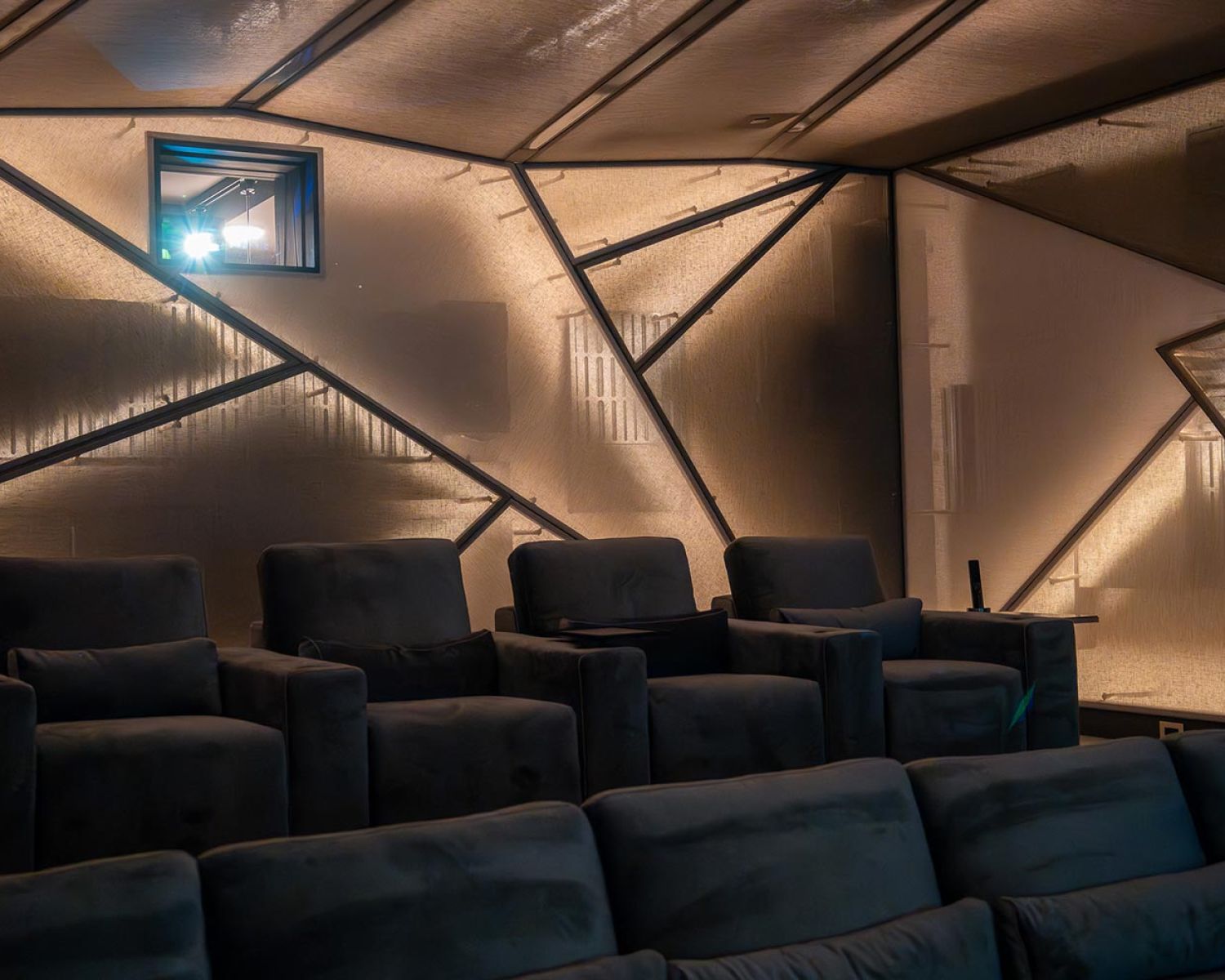 Home theater seating with geometric wall panels and soft lighting