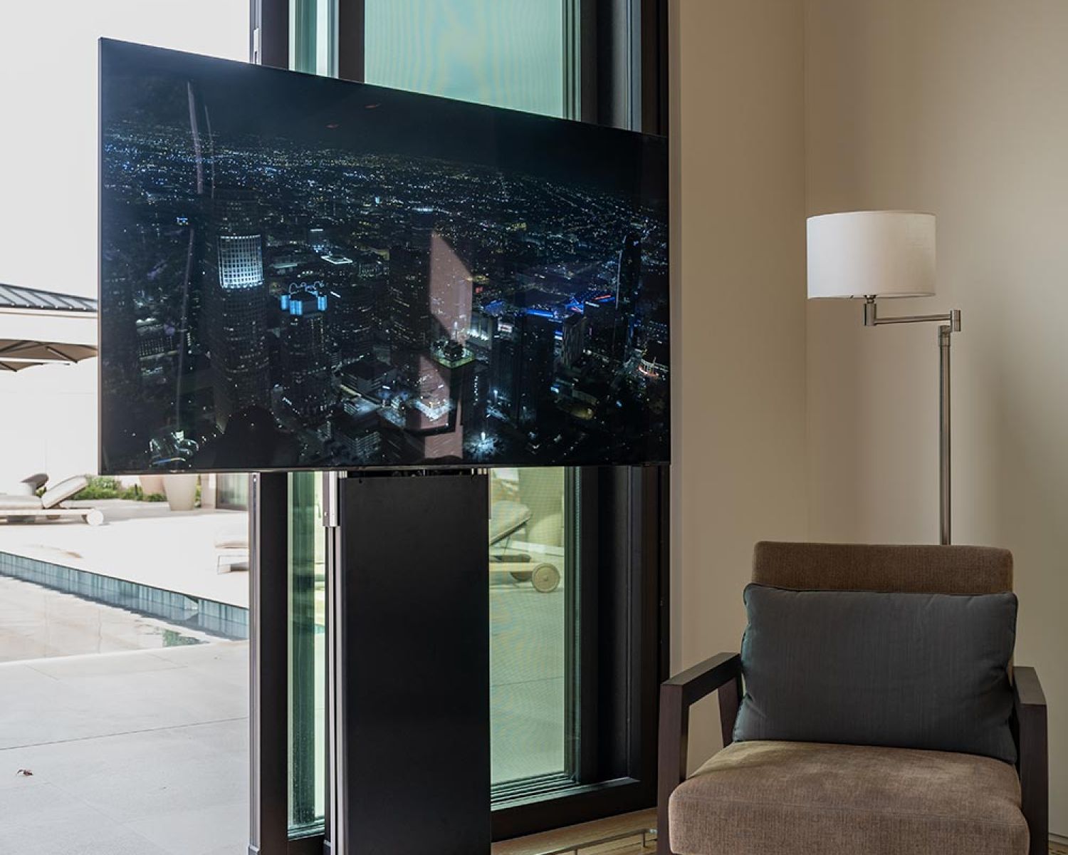 Motorized TV positioned beside sliding glass doors