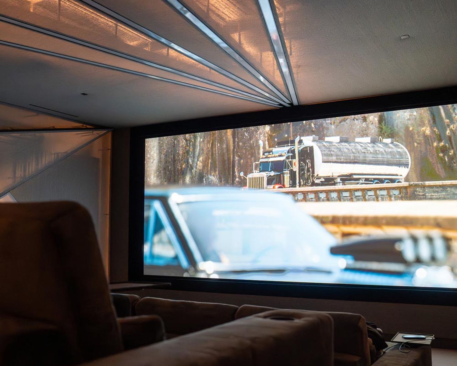 Home theater seating facing large projection screen