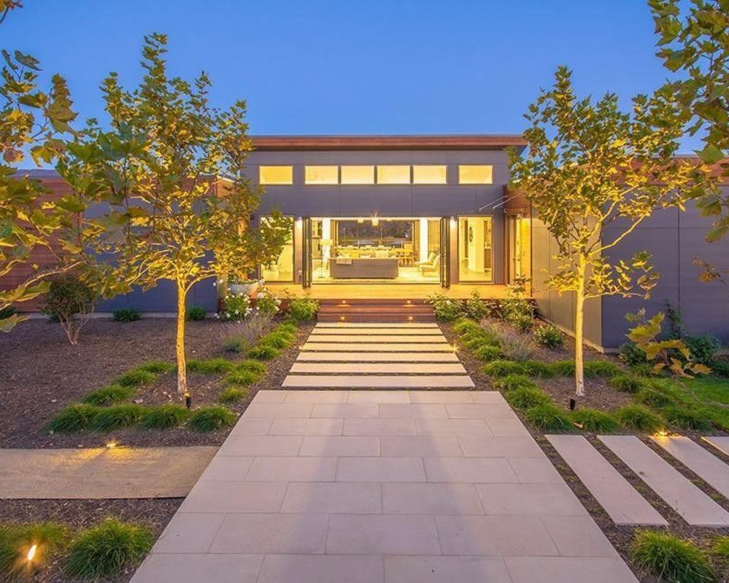 modern home lit up and dusk