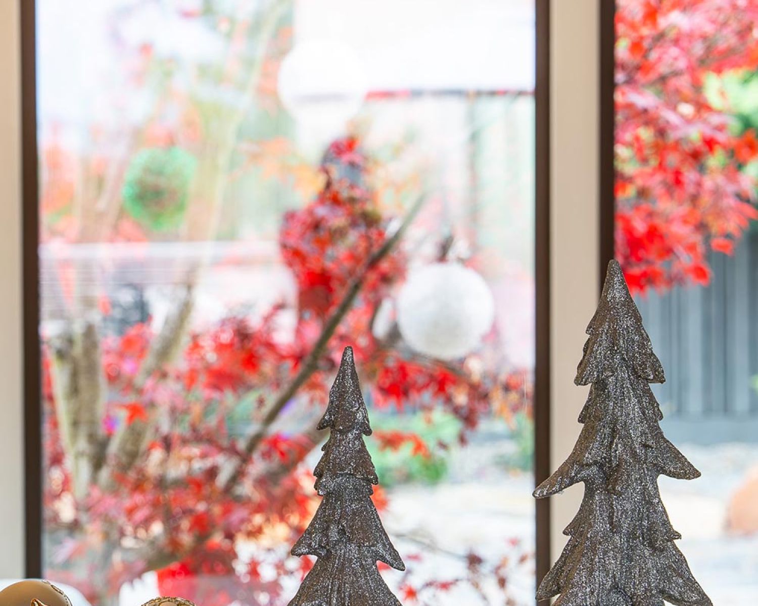 Holiday decor with decorative trees near large window