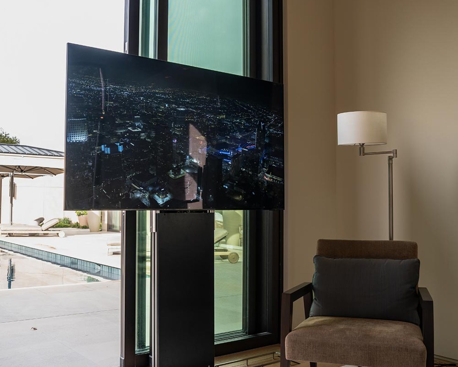 Living area with retractable TV near outdoor patio