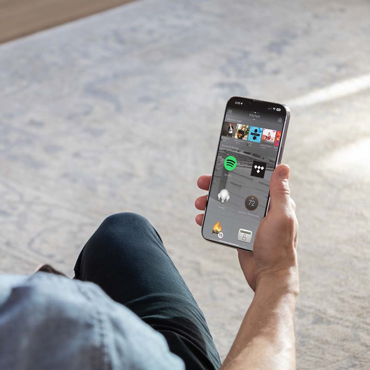 A sleek Control4 touch panel mounted on a wall, displaying a modern home automation interface.