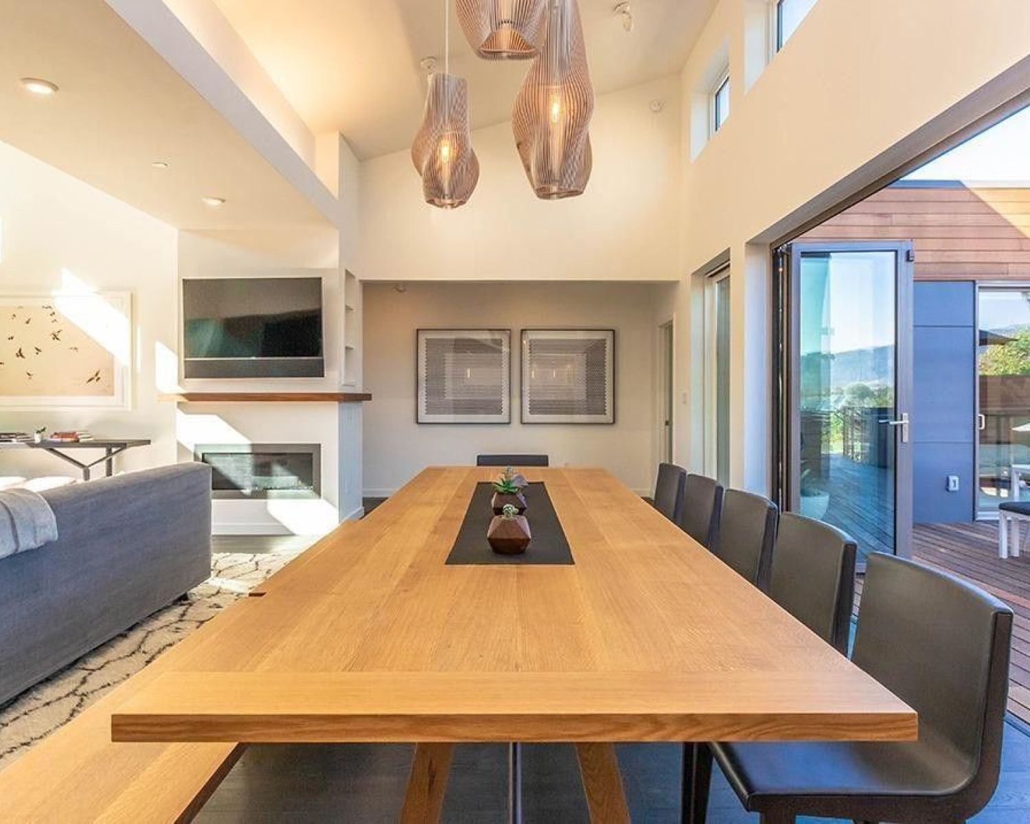 Wooden dining table beneath lighting fixture
