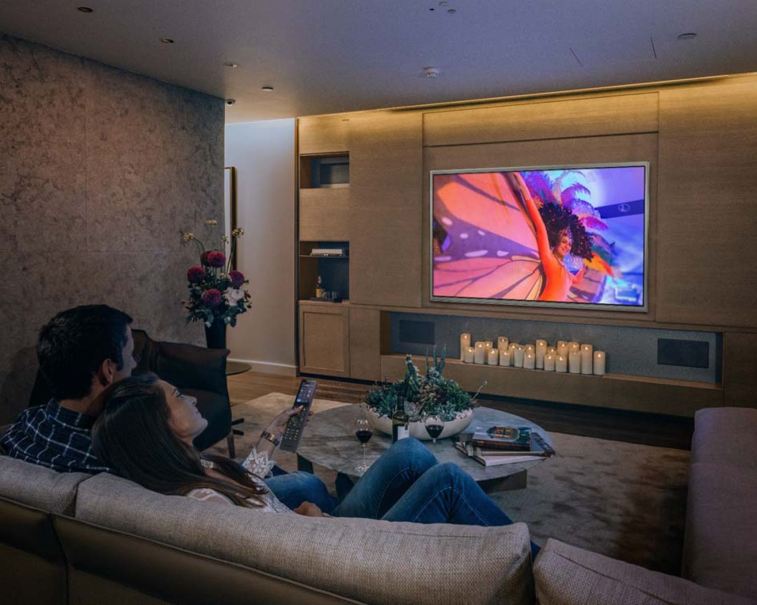 couple watching tv with a Crestron remote