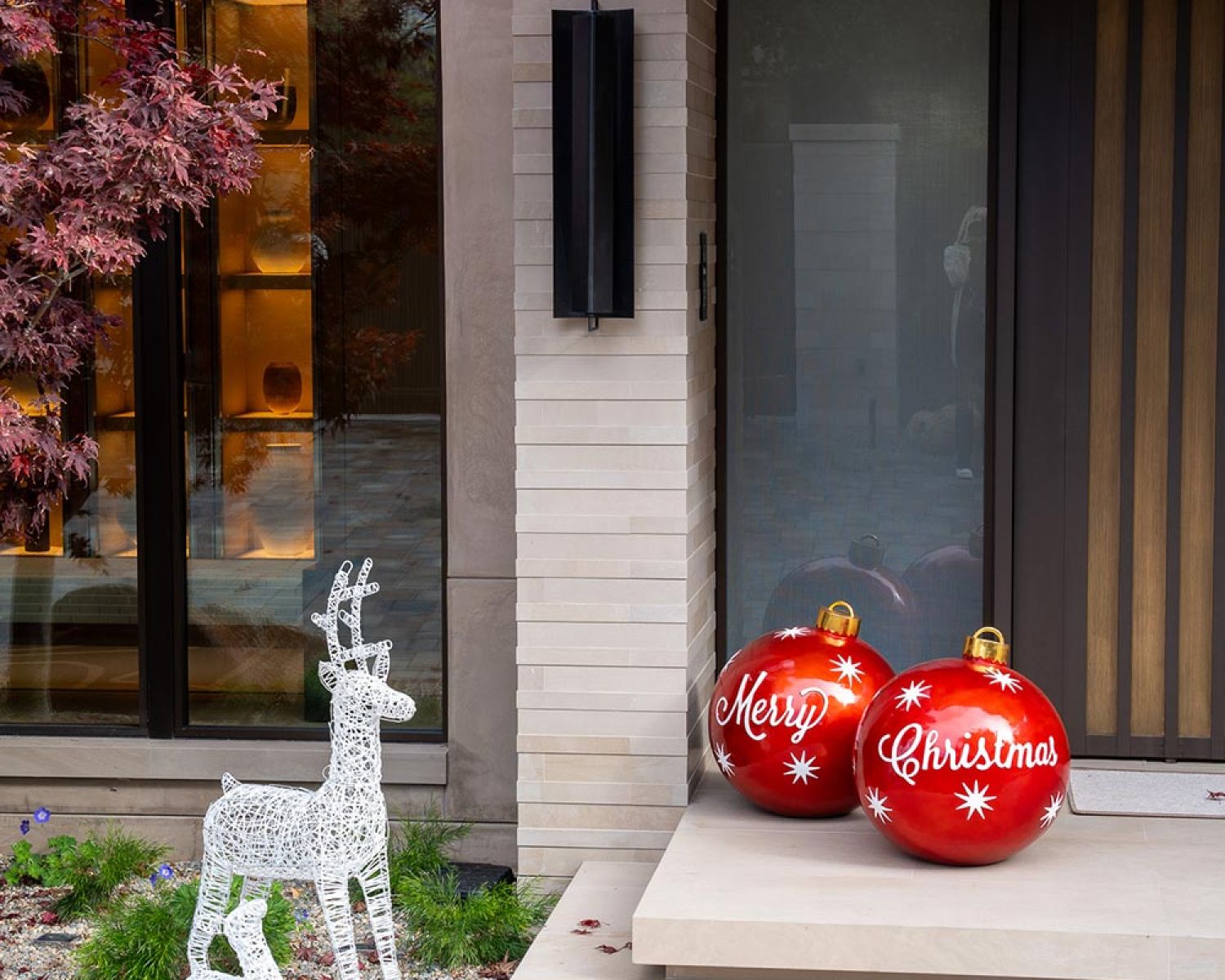 Modern home entry with seasonal decor and oversized ornaments
