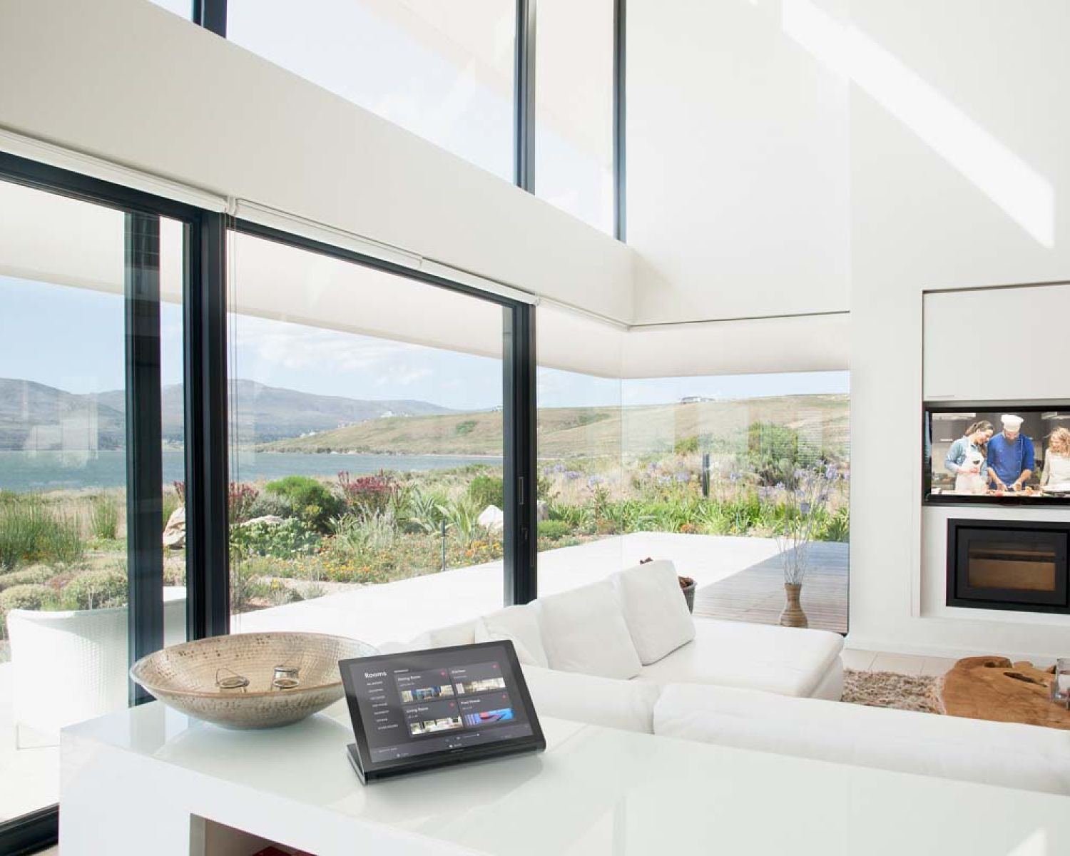 Crestron touch panel in modern home with glass walls
